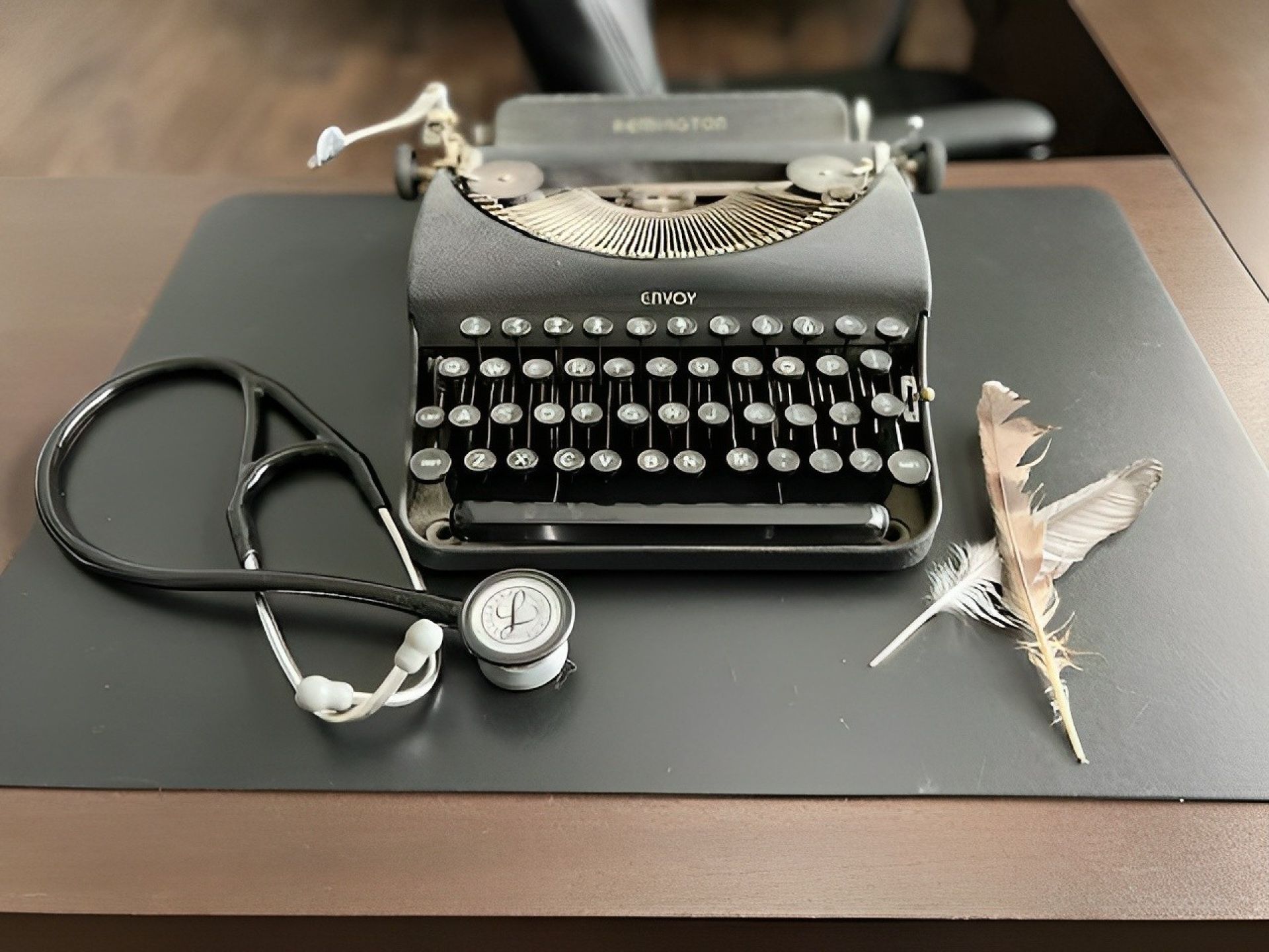 A type writer and a stethoscope on a desk